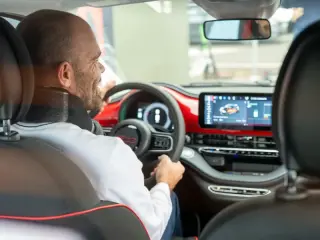 man laughing while driving an ev