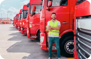 Man in front of lorries working for a HGV haulage business